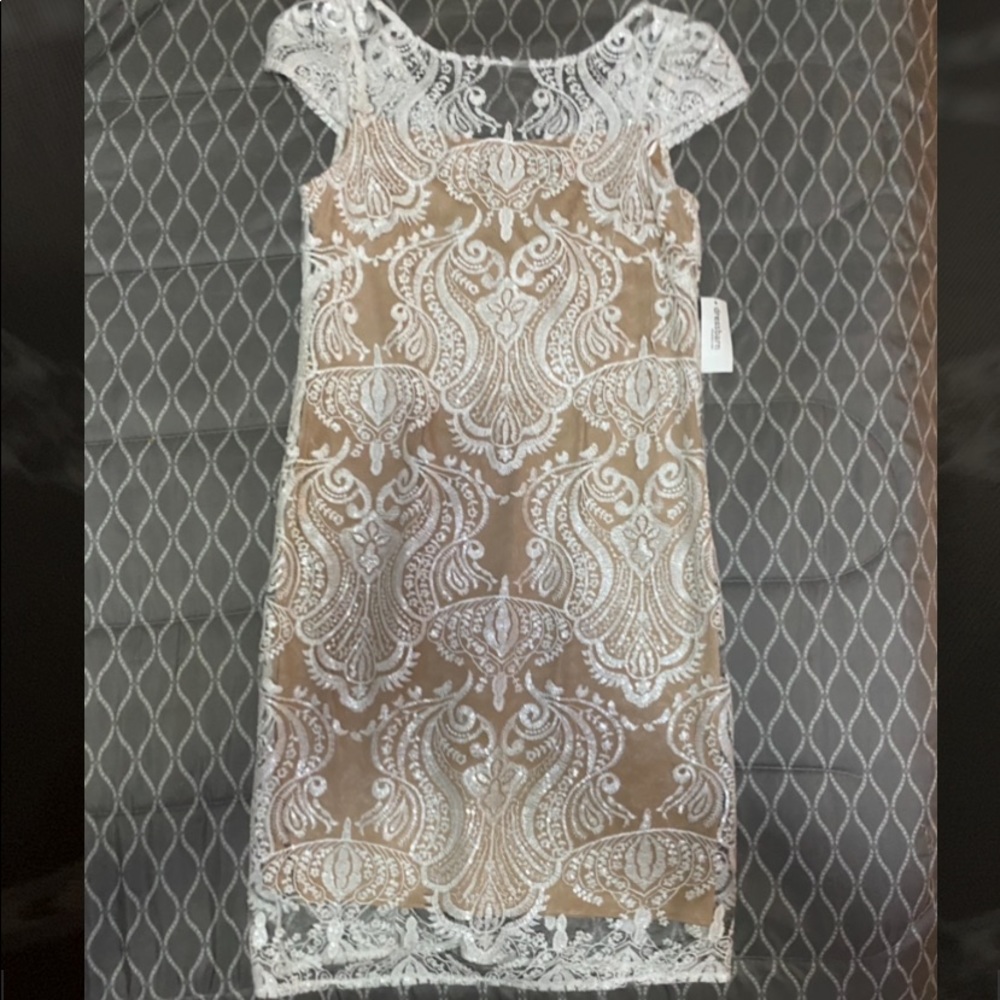 Cream and white dress with lace overlay.